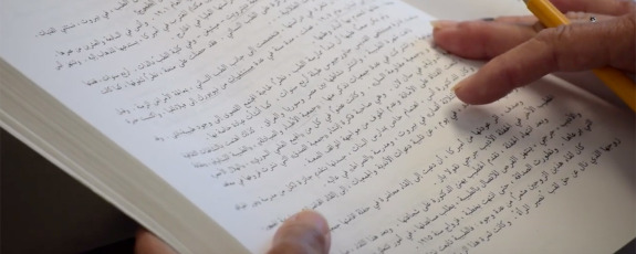 closeup of woman reading Arabic