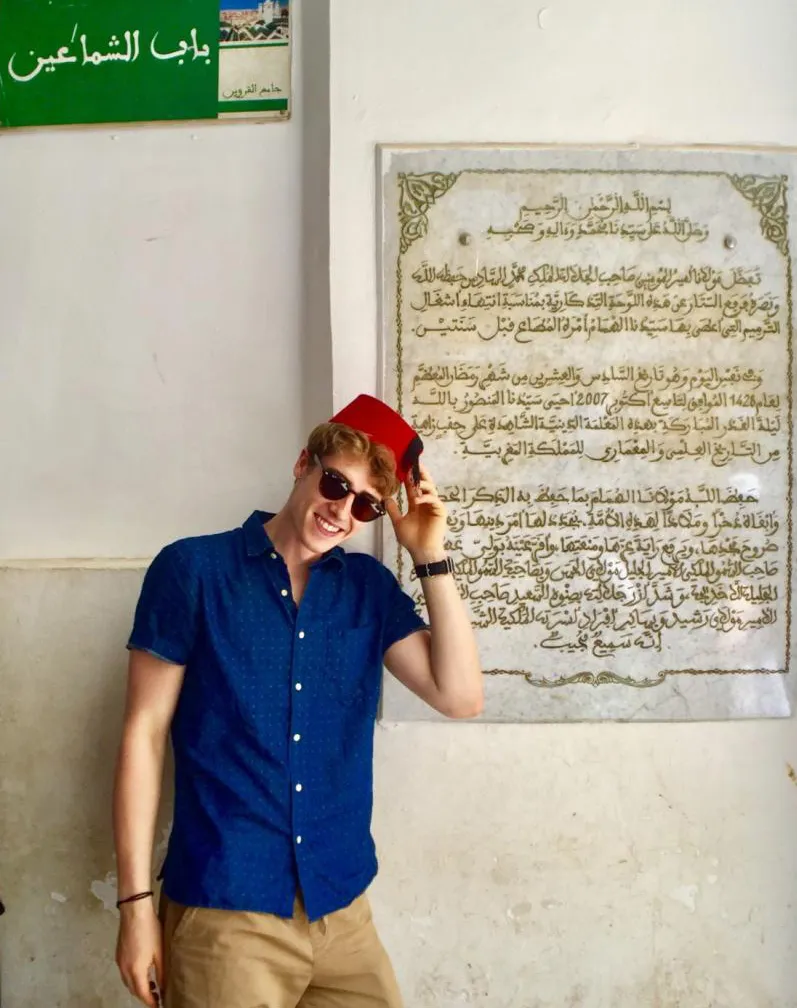 Student in front of Arabic sign in Fes